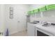 Laundry room with front loading washer and dryer, shelving and ironing board at 2924 Protagonist St, Kissimmee, FL 34746