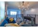 A relaxing living room with large windows, a foosball table and a comfortable sofa creates a calming atmosphere at 2924 Protagonist St, Kissimmee, FL 34746