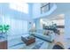 This bright living room features neutral walls, modern sofa, and access to the kitchen at 2924 Protagonist St, Kissimmee, FL 34746