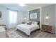 This bright main bedroom offers an accent wall, modern lighting fixtures, and a plush, comfortable carpet at 2924 Protagonist St, Kissimmee, FL 34746