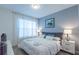 This cozy main bedroom features soft natural lighting, matching lamps, and a soft, comfortable comforter at 2924 Protagonist St, Kissimmee, FL 34746