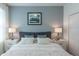 This cozy main bedroom features matching lamps and a soft, comfortable comforter at 2924 Protagonist St, Kissimmee, FL 34746