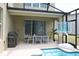 Enjoy outdoor living on the screened patio with a dining area, grill, and a basketball court at 2924 Protagonist St, Kissimmee, FL 34746
