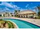 Community pool area with lazy river and tiki bar under a sunny, cloudy sky at 2924 Protagonist St, Kissimmee, FL 34746