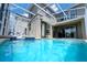 Refreshing pool area surrounded by a screened enclosure offers an ideal space for relaxation and recreation at 2924 Protagonist St, Kissimmee, FL 34746