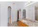Bathroom featuring a granite countertop vanity and decorative elements at 30108 Pga Dr, Sorrento, FL 32776