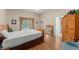 Bright bedroom with a large window and wood-look flooring at 30108 Pga Dr, Sorrento, FL 32776