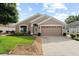 Charming single-Gathering home with a well-manicured lawn, two-car garage, and inviting curb appeal at 30108 Pga Dr, Sorrento, FL 32776