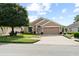 Inviting single-story home showcases a well-maintained lawn, attractive landscaping, and a two-car garage at 30108 Pga Dr, Sorrento, FL 32776