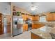 Updated kitchen with stainless steel appliances, tile floor, granite countertops and stylish cabinetry at 30108 Pga Dr, Sorrento, FL 32776
