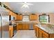 Modern kitchen featuring stainless steel appliances, granite counters, and ample cabinet space at 30108 Pga Dr, Sorrento, FL 32776