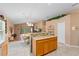 Well-lit kitchen features granite countertops and an adjacent dining area at 30108 Pga Dr, Sorrento, FL 32776