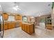 Well-equipped kitchen with stainless steel appliances, granite countertops, and tile flooring at 30108 Pga Dr, Sorrento, FL 32776
