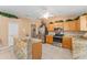 Bright kitchen features stainless steel appliances and granite countertops at 30108 Pga Dr, Sorrento, FL 32776