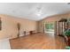 Spacious living room featuring wood flooring and access to the backyard at 30108 Pga Dr, Sorrento, FL 32776