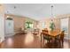 Well-lit living and dining room with wood floors, cozy seating, and charming decor at 30108 Pga Dr, Sorrento, FL 32776