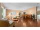 Spacious living and dining area featuring wood floors and large windows for natural light at 30108 Pga Dr, Sorrento, FL 32776