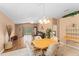 Open living room with dining area and sliding door to backyard at 30108 Pga Dr, Sorrento, FL 32776