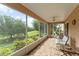 Relaxing screened patio with beautiful tile flooring and lovely views of the lush green landscape at 30108 Pga Dr, Sorrento, FL 32776