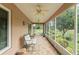 Inviting screened patio with comfortable seating and serene views of the meticulously maintained backyard at 30108 Pga Dr, Sorrento, FL 32776