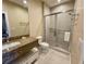 Modern bathroom with granite vanity, tiled floors, and glass-enclosed shower at 3235 Brasilia Ave, Kissimmee, FL 34747