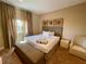 Serene bedroom with a king-sized bed, soft lighting, and neutral decor for a relaxing ambiance at 3235 Brasilia Ave, Kissimmee, FL 34747