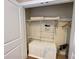 Storage closet features shelving, towel set, garment hangers, and mini drawers at 3235 Brasilia Ave, Kissimmee, FL 34747