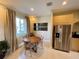 Cozy dining area with wood table, ample natural light, and stainless steel refrigerator at 3235 Brasilia Ave, Kissimmee, FL 34747