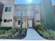 Charming two-story home featuring a balcony, stucco facade, and well-maintained landscaping at 3235 Brasilia Ave, Kissimmee, FL 34747