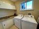 Functional laundry room featuring granite countertops, sink, washer, and dryer at 3235 Brasilia Ave, Kissimmee, FL 34747