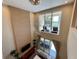 Upstairs view of a cozy living room with large windows and elegant chandelier at 3235 Brasilia Ave, Kissimmee, FL 34747