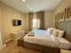 Comfortable main bedroom featuring a king bed, TV, and a serene, neutral color palette at 3235 Brasilia Ave, Kissimmee, FL 34747