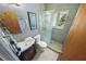 Modern bathroom featuring a glass-enclosed shower and stylish round mirror above vanity at 328 E Minnehaha Ave, Clermont, FL 34711