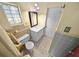 Compact bathroom featuring tile floor, a single vanity, and unique window design at 328 E Minnehaha Ave, Clermont, FL 34711