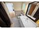 Bathroom featuring neutral wall tiles, vanity sink, and checkered-tile flooring at 328 E Minnehaha Ave, Clermont, FL 34711