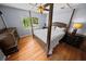 Bright bedroom showcasing a four-poster bed and lustrous hardwood flooring at 328 E Minnehaha Ave, Clermont, FL 34711
