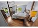 Charming bedroom with a four-poster bed and hardwood floors with sunlit windows at 328 E Minnehaha Ave, Clermont, FL 34711