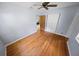Bedroom featuring hardwood floors, a ceiling fan and adjacent closet with a white folding door at 328 E Minnehaha Ave, Clermont, FL 34711
