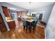 Dining area with hardwood floors, contemporary lighting, and backyard views through a large window at 328 E Minnehaha Ave, Clermont, FL 34711