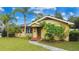 Charming one-story home with a well-maintained lawn and mature landscaping at 328 E Minnehaha Ave, Clermont, FL 34711