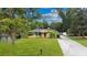 Charming single-story home with lush green lawn and mature trees providing shade and curb appeal at 328 E Minnehaha Ave, Clermont, FL 34711