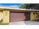 Detached one car garage with a traditional garage door in a well kept yard at 328 E Minnehaha Ave, Clermont, FL 34711