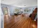 Bright living room featuring hardwood floors and large windows offering serene backyard views at 328 E Minnehaha Ave, Clermont, FL 34711
