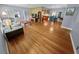 Open concept living room featuring hardwood floors seamlessly connecting to the dining and kitchen areas at 328 E Minnehaha Ave, Clermont, FL 34711