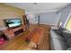 Spacious living room features hardwood floors, a decorative wood wall, and ample natural light at 328 E Minnehaha Ave, Clermont, FL 34711