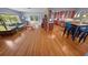 Open-concept living space with hardwood floors connecting the living room, kitchen and dining areas at 328 E Minnehaha Ave, Clermont, FL 34711