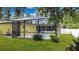 Screened in Pool area with well maintained landscaping, creating a private outdoor oasis for relaxation and entertainment at 328 E Minnehaha Ave, Clermont, FL 34711