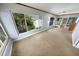 Bright sunroom featuring large windows offering serene outdoor views and neutral carpet at 328 E Minnehaha Ave, Clermont, FL 34711