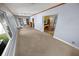 Light-filled sunroom with neutral carpeting, open doorway, and views to the backyard at 328 E Minnehaha Ave, Clermont, FL 34711