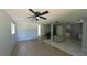 Spacious open-concept living area with a ceiling fan and a view to the kitchen at 39 S College Ave, Maitland, FL 32751